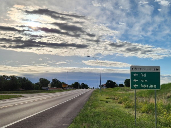 Wayfinding sign with blue sky and clouds