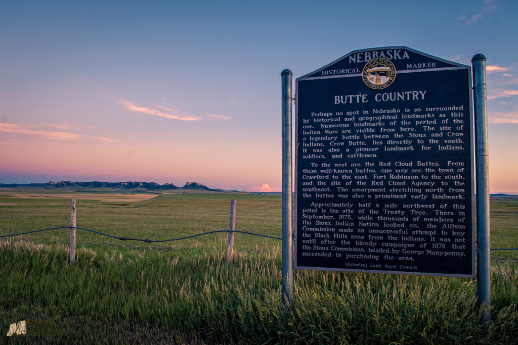 Butte Country state historical marker with buttes in the background