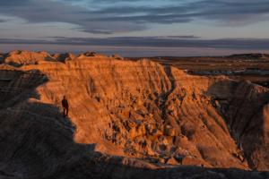 Man walking along ridge at Toadstool Geologic Park