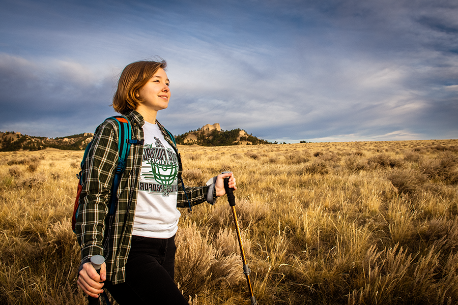 Girl hiking with buttes in the background