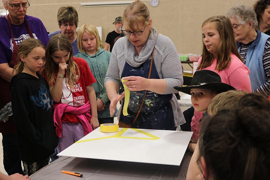 A group of people learn how to make barn quilts