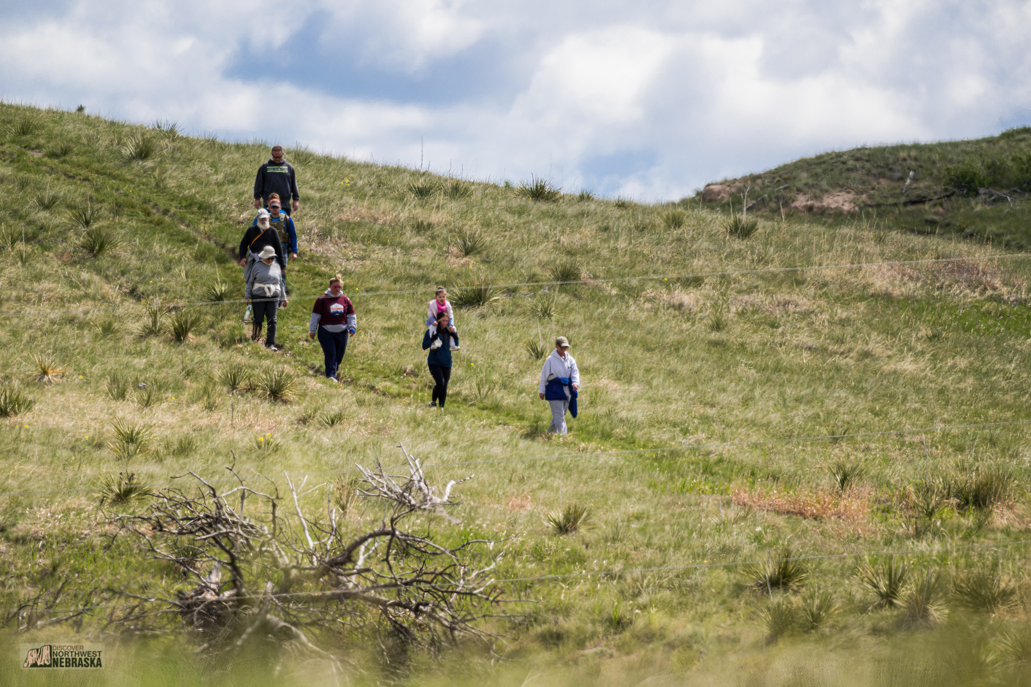 Several people down a hill in the distance.