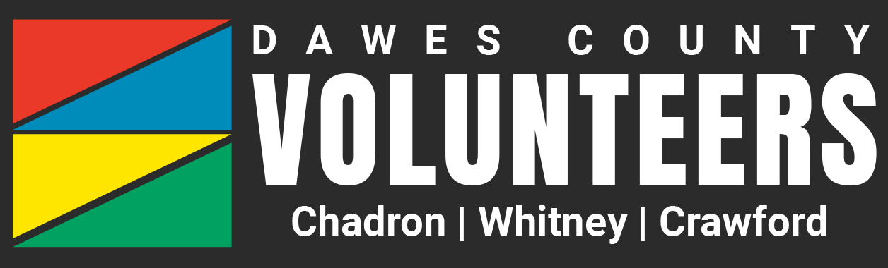 A logo featuring red, blue, yellow and green triangles stacked on top of each other in a square and the words Dawes County Volunteers: Chadron, Whitney, Crawford