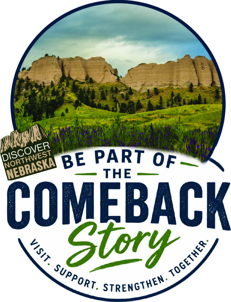 A logo that reads "Be Part of the Comeback Story. Visit. Support. Strengthen. Together." with a photo of buttes rising above a field of green grass and purple flowers.